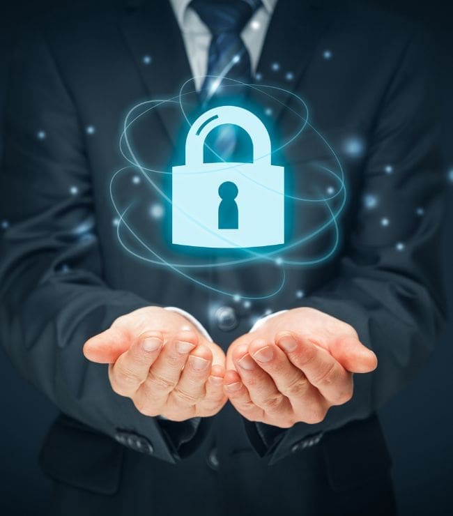 Businessman holding a glowing lock symbol.